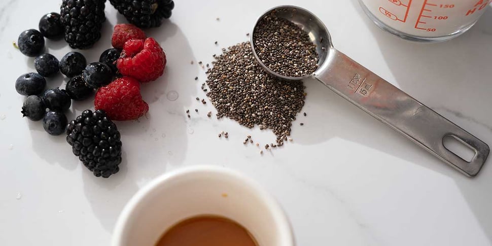 ingredients for chia seed pudding placed on a white background