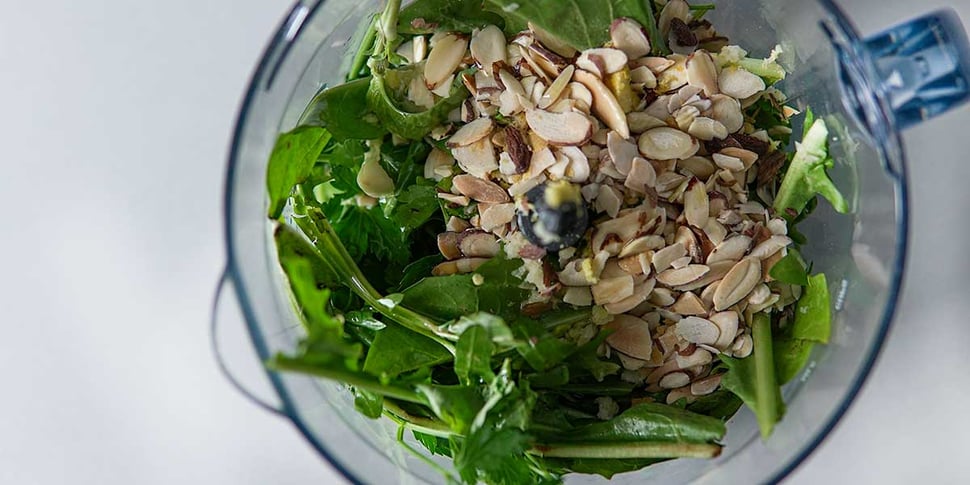 blending ingredients for healthy pesto recipe 