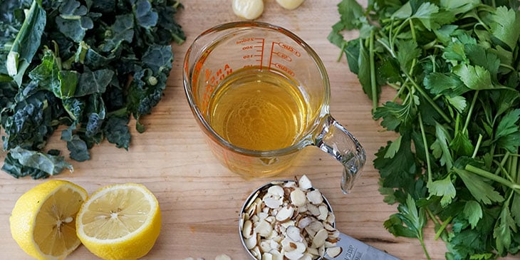 kale pesto recipe ingredients on cutting board for meal prep 