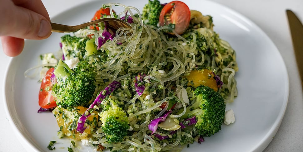 pesto and kelp noodle bowl plated on a white round plate