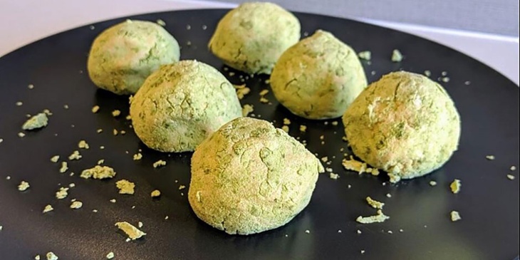 Green tea matcha fat bombs plated on a circular black plate