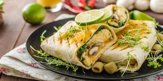 meal prep breakfast burrito served on a black plate