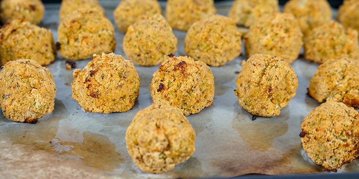 Cooked Paleo Broccoli Crispy Tots on a sheet tray slightly golden brown