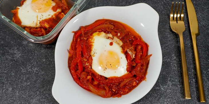 Paleo Shakshouka Breakfast on a round white plate next to golden silverware