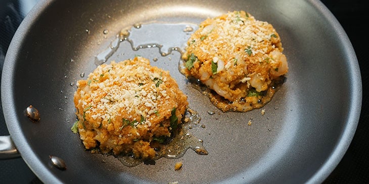 cooking shrimp burgers in saute pan 