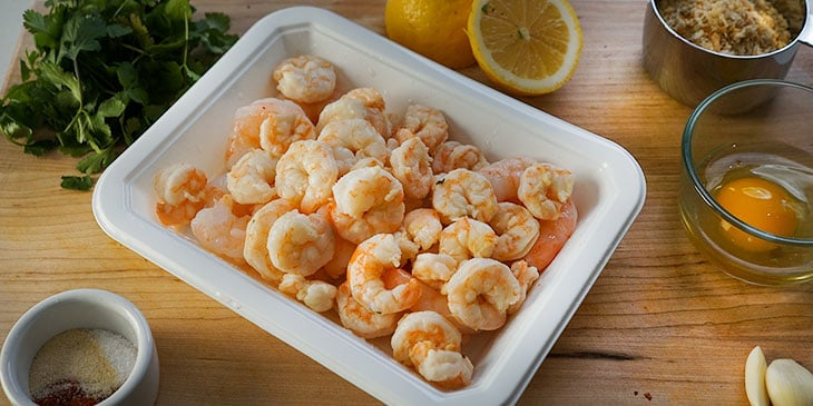 ingredients for crispy shrimp burger on cutting board