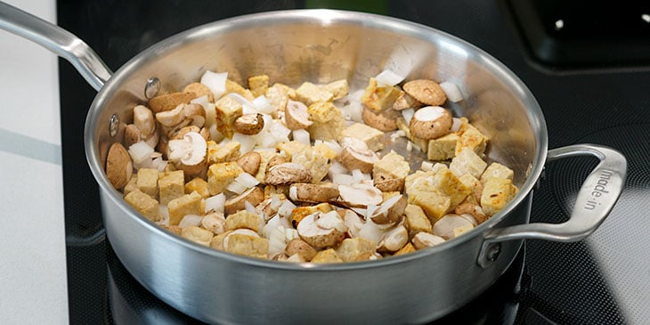 sauteing tempeh and vegetables in pot 